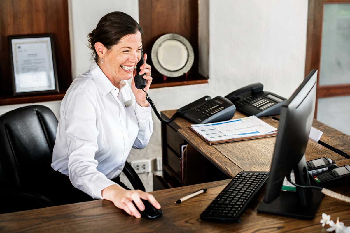 female-receptionist-working-front-desk